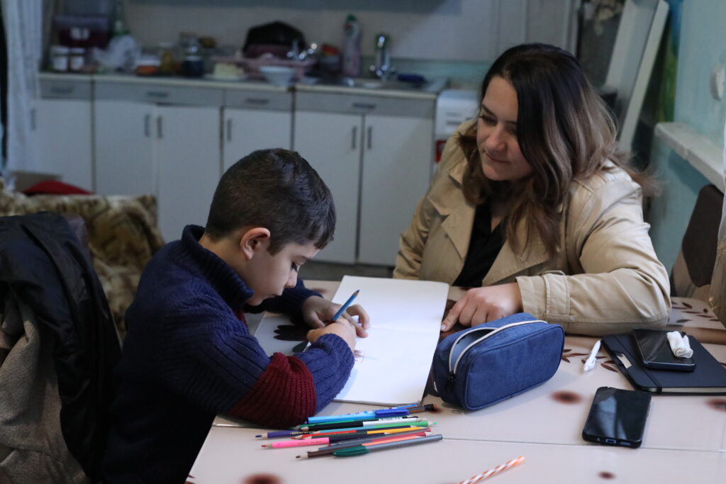 Social worker speaks with a boy in Armenia