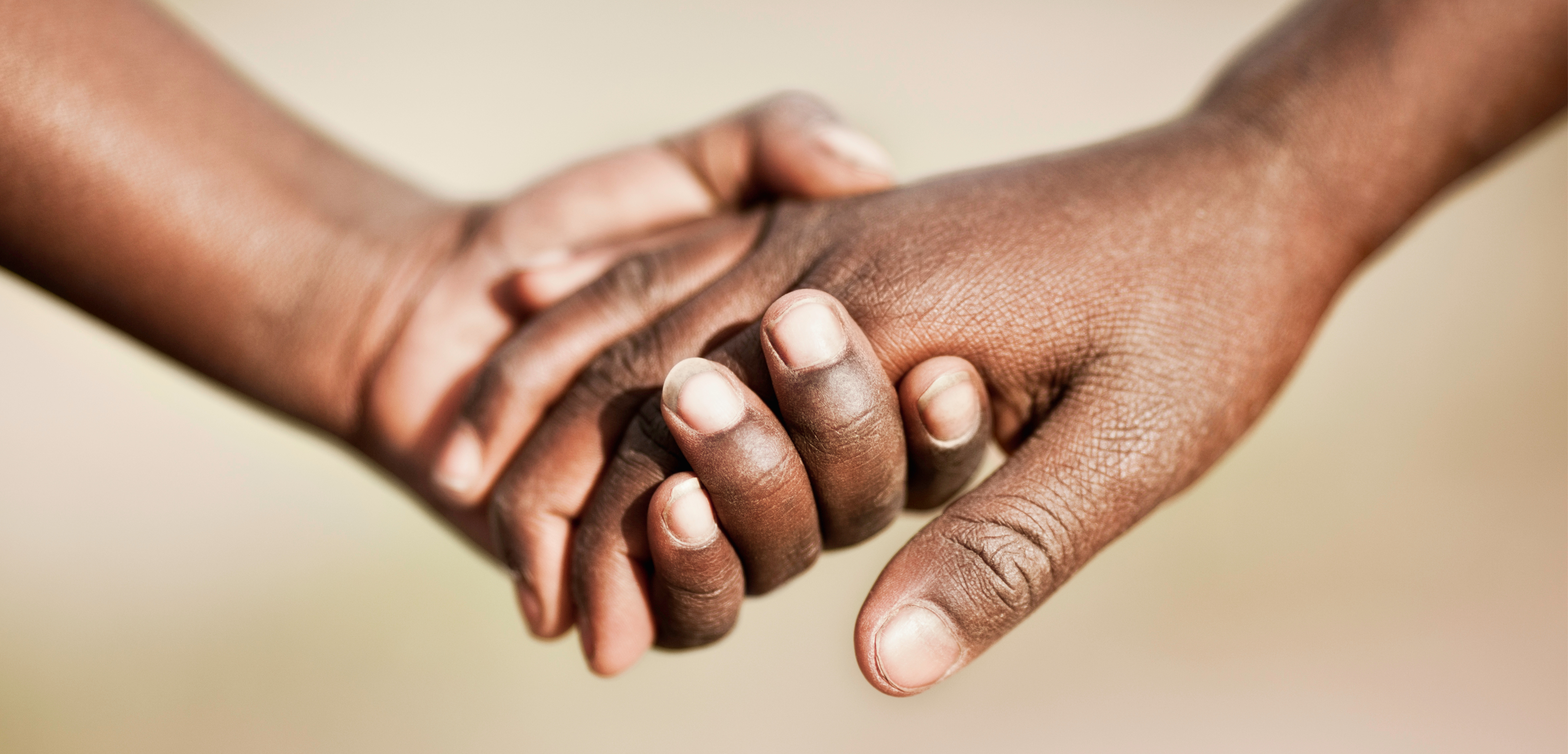 Image of two hands joining together